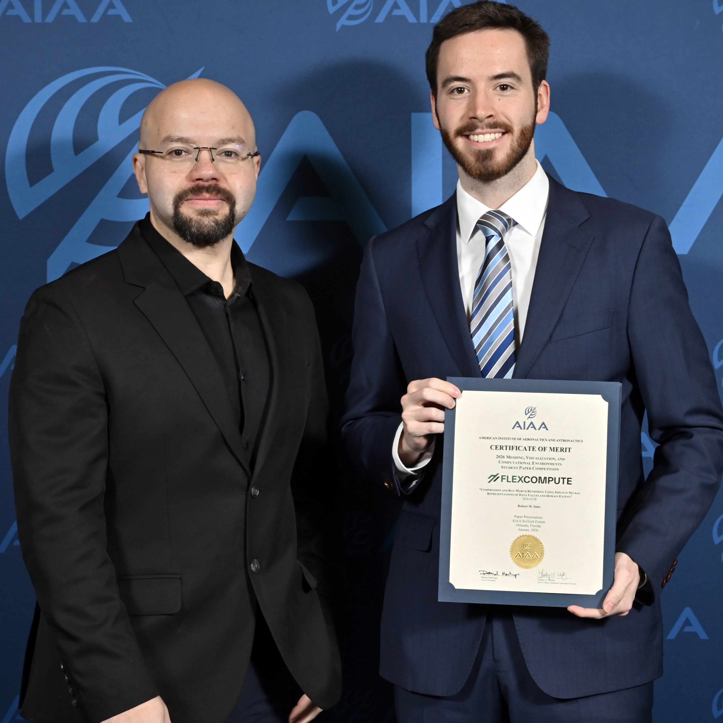 Mohammed Kamel presenting Robert Sales with the 2026 MVCE Best Student Paper award
