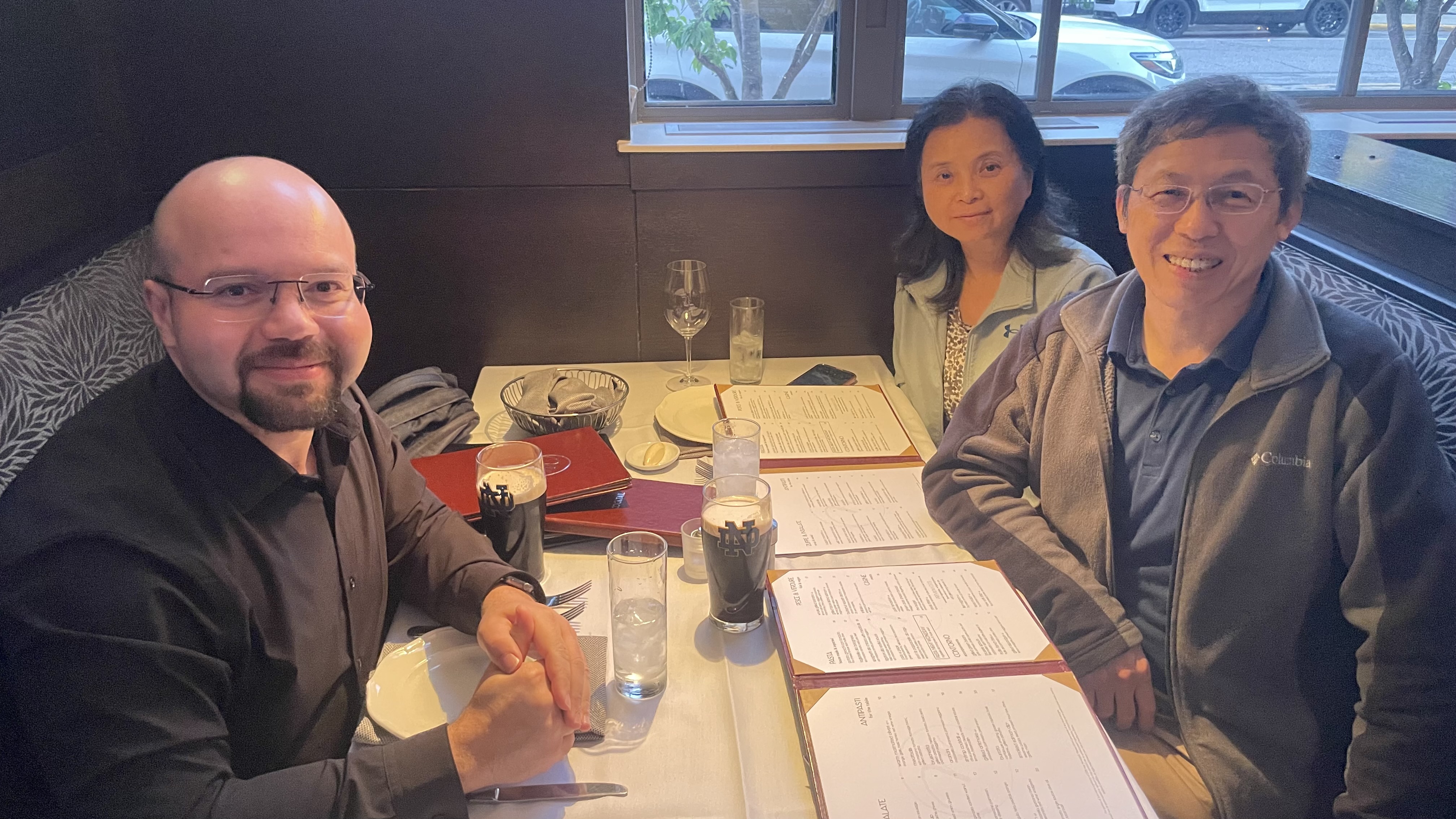 Mohammed Kamel having dinner with Professor Meng Wang and his wife during a visit to the University of Notre Dame